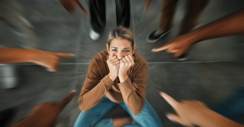 fear-bullying-hands-pointing-girl-scared-sad-crying-help-from-stress-depression-group-circle-judge-anxiety-woman-suffering-from-crowd-blame-trauma-emotional-pain a woman facing a social anxiety and bullying from classmates