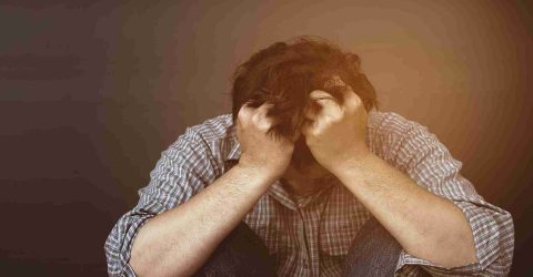 sad-man-holding-head-with-hand_11zon sad or depressed man holding head with hand