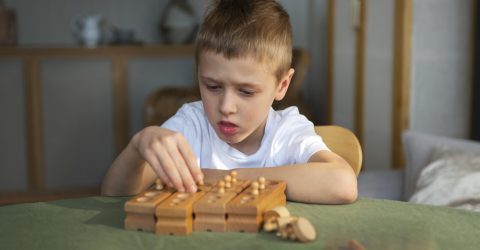 young-autistic-boy-playing-with-toys-home young-autistic-boy-playing-with-toys-home