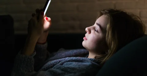 A girl using social media on midnight